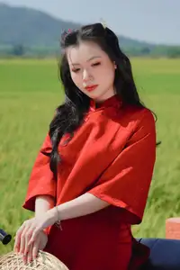 Discover the Serene Beauty: Vietnamese Girl in Red Ao Dai Amidst Green Rice Fields - image 2