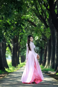 VGU No.150: Graceful Vietnamese Beauty in Pink Ao Dai on a Serene Path - image 2