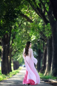 VGU No.150: Graceful Vietnamese Beauty in Pink Ao Dai on a Serene Path - image 1