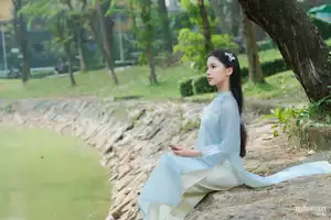 Elegant Vietnamese Maiden in Áo Dài Amidst Serene Nature's Embrace - image 4