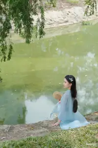 Elegant Vietnamese Maiden in Áo Dài Amidst Serene Nature's Embrace - image 2