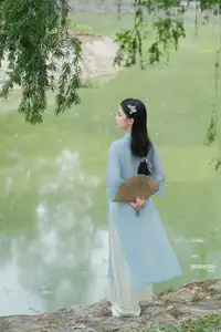Elegant Vietnamese Maiden in Áo Dài Amidst Serene Nature's Embrace - image 0