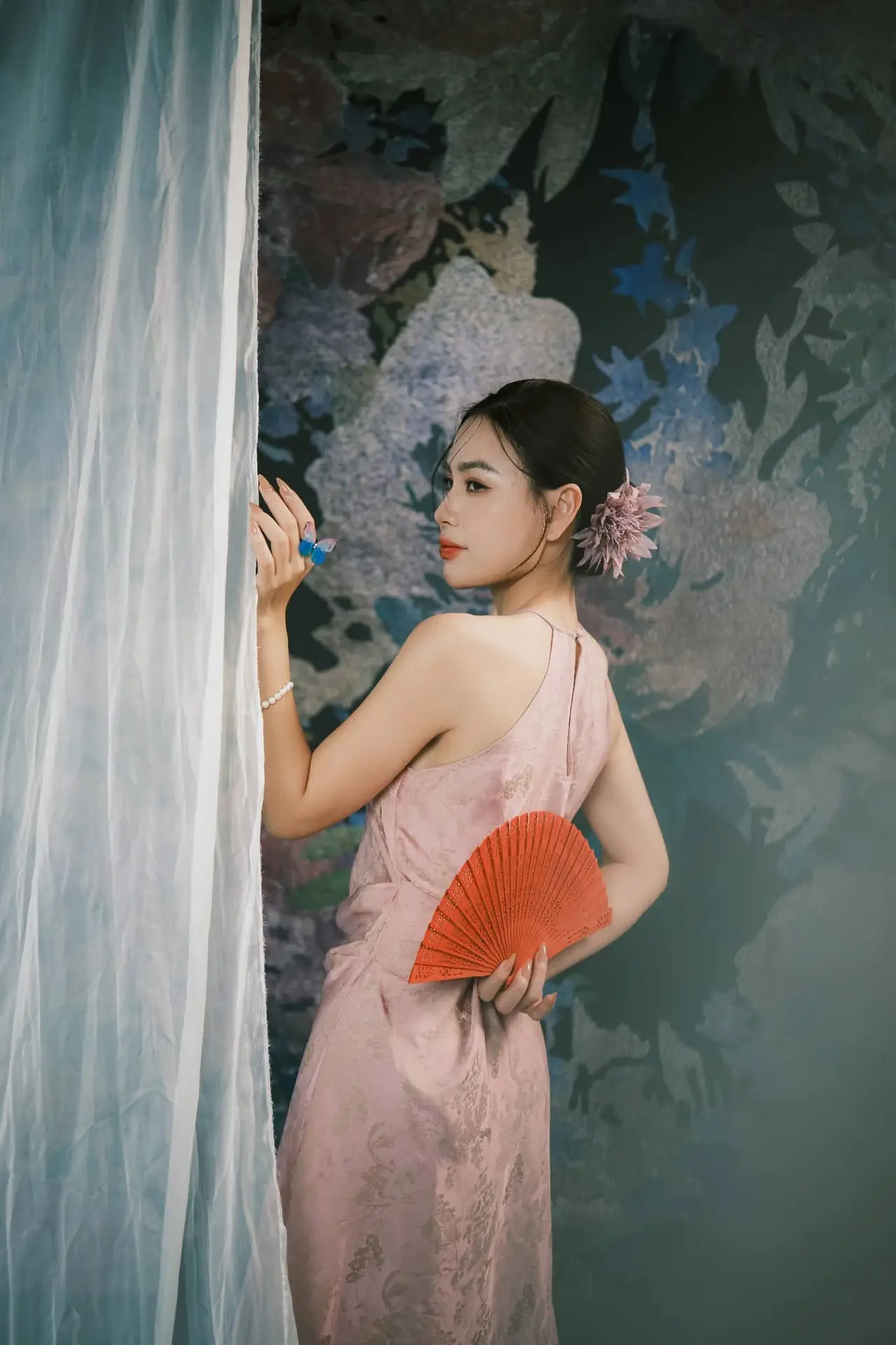 Discover Vietnamese Grace: An Elegant Girl in Ao Yem with a Red Fan.