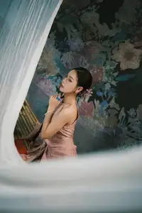 Discover Vietnamese Grace: An Elegant Girl in Ao Yem with a Red Fan. - image 1