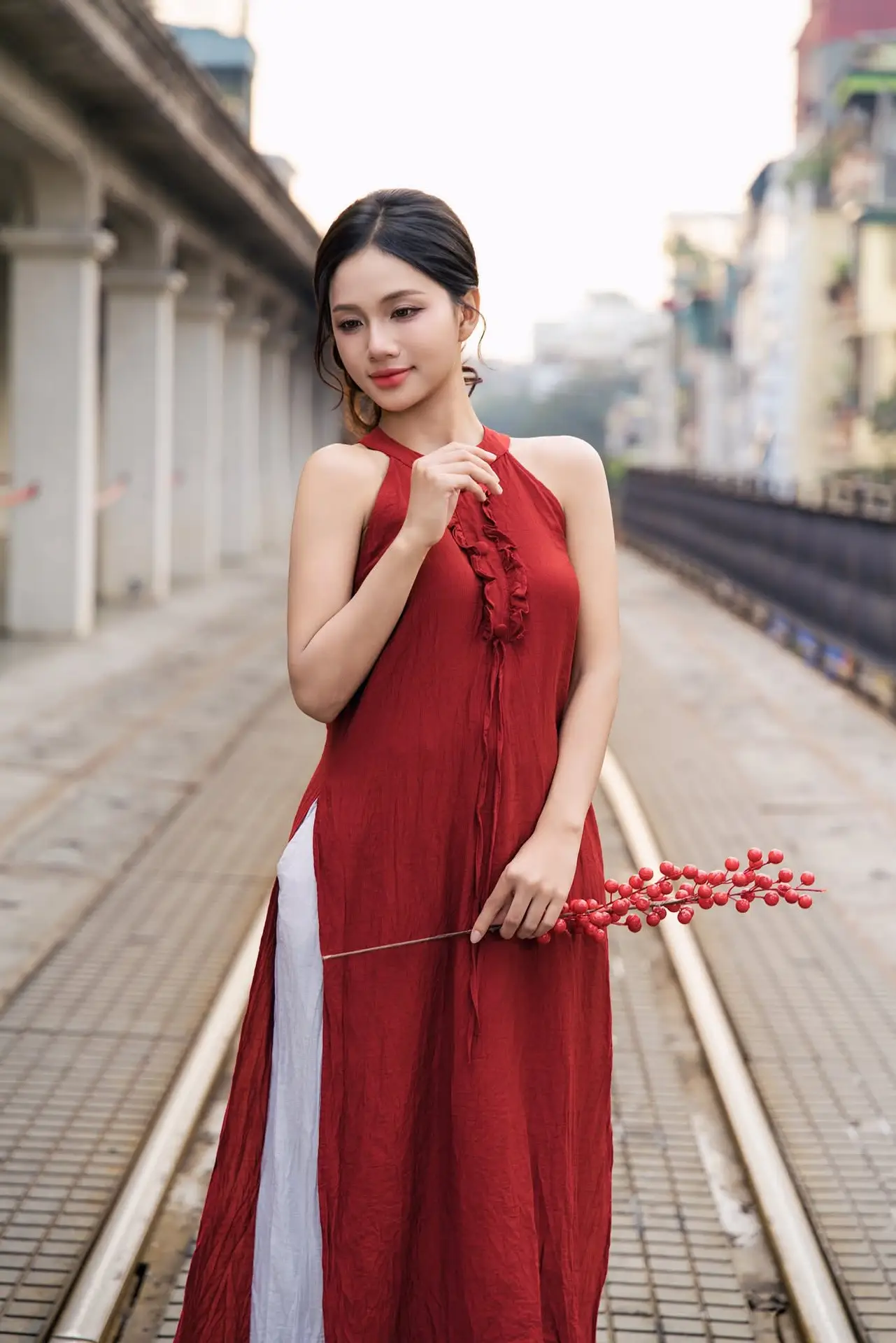 Gentle Vietnamese Girl in Red by Old Railway Bridge: Elegant Asian Beauty