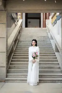 Serene Vietnamese Beauty: A Gentle Muse in White with Pink Lilies - image 5