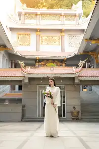 Serene Vietnamese Beauty: A Gentle Muse in White with Pink Lilies - image 0