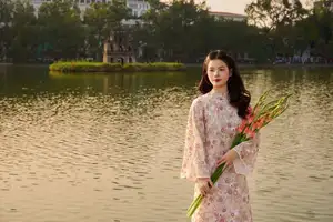 Vietnamese Ao Dai Beauty by the Lake at Sunset: Graceful Girl with Vibrant Gladiolus Flowers. - image 4
