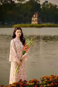 Vietnamese Ao Dai Beauty by the Lake at Sunset: Graceful Girl with Vibrant Gladiolus Flowers. - image 3