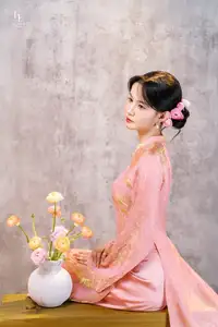 Elegant Asian Charm: Serene Young Woman in Traditional Pink Attire with Delicate Fresh Flowers - image 6