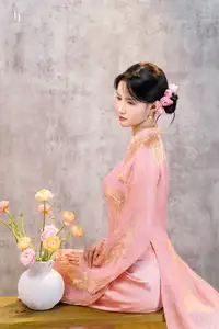 Elegant Asian Charm: Serene Young Woman in Traditional Pink Attire with Delicate Fresh Flowers - image 7