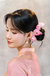 Elegant Asian Charm: Serene Young Woman in Traditional Pink Attire with Delicate Fresh Flowers - image 2