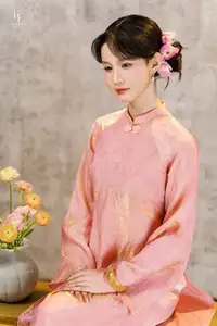 Elegant Asian Charm: Serene Young Woman in Traditional Pink Attire with Delicate Fresh Flowers - image 1