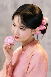 Elegant Asian Charm: Serene Young Woman in Traditional Pink Attire with Delicate Fresh Flowers - image 5