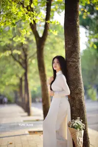 Captivating Beauty: Vietnamese Girl in White Ao Dai with Delicate Daisies. - image 5