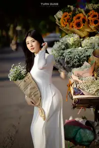 Captivating Beauty: Vietnamese Girl in White Ao Dai with Delicate Daisies. - image 8