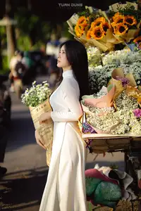 Captivating Beauty: Vietnamese Girl in White Ao Dai with Delicate Daisies. - image 9