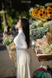 Captivating Beauty: Vietnamese Girl in White Ao Dai with Delicate Daisies. - image 3