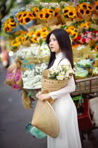 Captivating Beauty: Vietnamese Girl in White Ao Dai with Delicate Daisies. - image 10