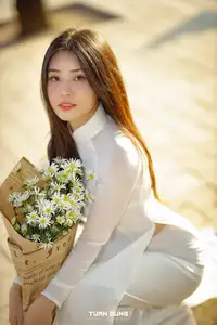 Captivating Beauty: Vietnamese Girl in White Ao Dai with Delicate Daisies. - image 12