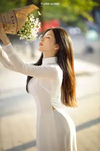 Captivating Beauty: Vietnamese Girl in White Ao Dai with Delicate Daisies. - image 13