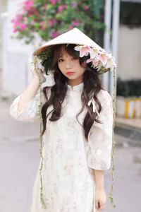 VGU No.143: Discover the Ethereal Beauty of a Vietnamese Girl in Ao Dai and Floral Conical Hat - image 0