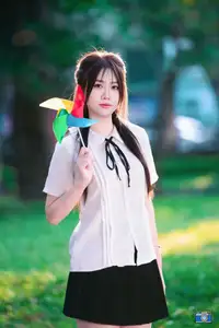 Radiant Youth: Vietnamese Girl's Bright Smile with Pinwheel in Golden Sunlight - image 7