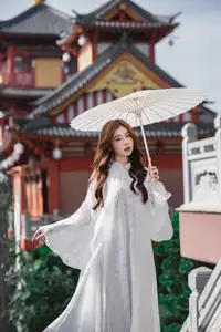 Explore Ethereal Asian Beauty: A Graceful Girl in White Ao Dai Amidst Ancient Oriental Charm - image 0