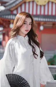 Explore Ethereal Asian Beauty: A Graceful Girl in White Ao Dai Amidst Ancient Oriental Charm - image 1