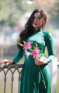 Vietnamese Grace: Elegant Woman in Green Ao Dai with Pink Lotus Flower 1000025232 - image 6