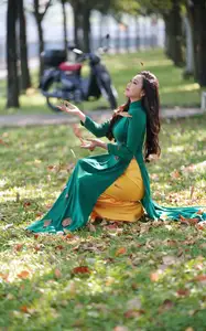 Vietnamese Grace: Elegant Woman in Green Ao Dai with Pink Lotus Flower 1000025232 - image 12