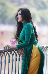 Vietnamese Grace: Elegant Woman in Green Ao Dai with Pink Lotus Flower 1000025232 - image 9