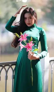 Vietnamese Grace: Elegant Woman in Green Ao Dai with Pink Lotus Flower 1000025232 - image 13
