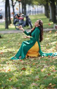Vietnamese Grace: Elegant Woman in Green Ao Dai with Pink Lotus Flower 1000025232 - image 14