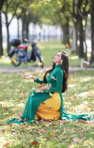 Vietnamese Grace: Elegant Woman in Green Ao Dai with Pink Lotus Flower 1000025232 - image 8