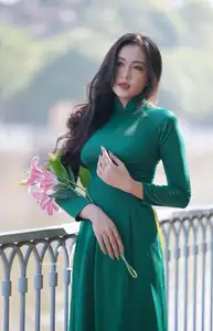 Vietnamese Grace: Elegant Woman in Green Ao Dai with Pink Lotus Flower 1000025232 - image 5