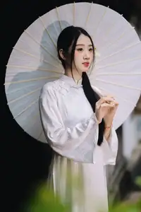 Discover the Grace of a Vietnamese Woman in White Ao Dai with Elegant Lilies - image 2
