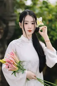 Discover the Grace of a Vietnamese Woman in White Ao Dai with Elegant Lilies - image 6