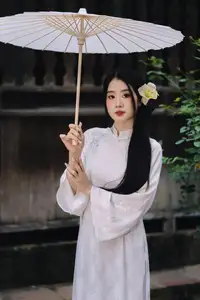 Discover the Grace of a Vietnamese Woman in White Ao Dai with Elegant Lilies - image 11