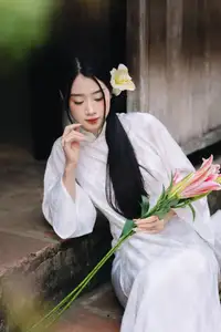 Discover the Grace of a Vietnamese Woman in White Ao Dai with Elegant Lilies - image 7