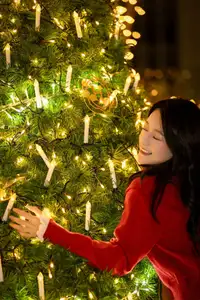 Radiant Smile Girl in Red Amidst Twinkling Lights: Warm Beauty for Festive Season - image 1