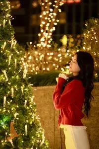 Radiant Smile Girl in Red Amidst Twinkling Lights: Warm Beauty for Festive Season - image 7