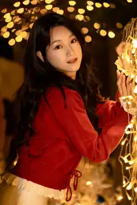 Radiant Smile Girl in Red Amidst Twinkling Lights: Warm Beauty for Festive Season - image 0