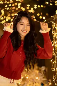 Radiant Smile Girl in Red Amidst Twinkling Lights: Warm Beauty for Festive Season - image 2