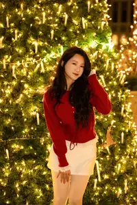 Radiant Smile Girl in Red Amidst Twinkling Lights: Warm Beauty for Festive Season - image 17