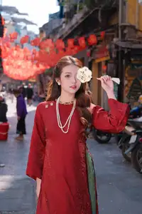 Elegant Vietnamese Beauty: A Girl in Red Ao Dai with Lilies Captivates Urban Charm - image 2
