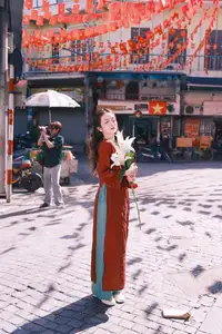 Elegant Vietnamese Beauty: A Girl in Red Ao Dai with Lilies Captivates Urban Charm - image 8