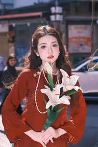 Elegant Vietnamese Beauty: A Girl in Red Ao Dai with Lilies Captivates Urban Charm - image 5