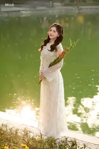 Graceful Ao Dai Vietnamese Beauty Shines Brightly By Serene Lake A Timeless Portrait - image 1