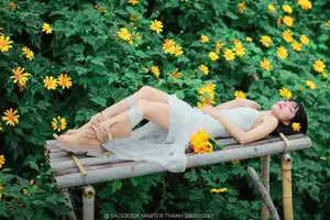 Graceful Young Woman in White Dress Amidst Vibrant Yellow Flowers 1000026997 - image 9